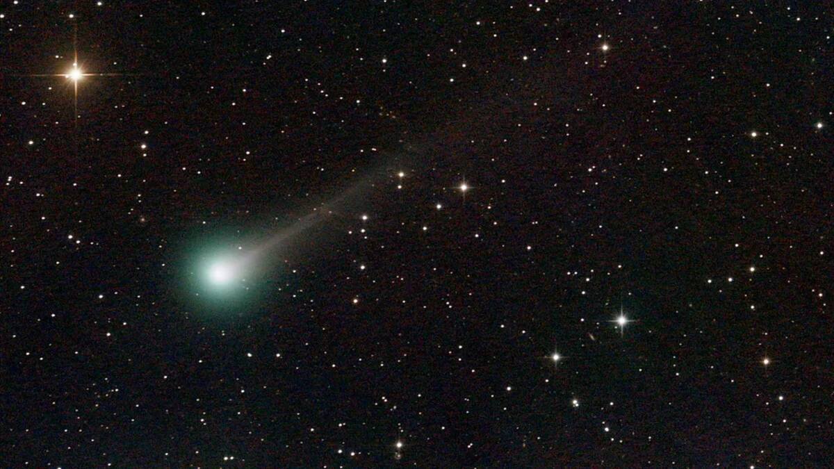Czech family observing comet with binoculars in countryside at dusk