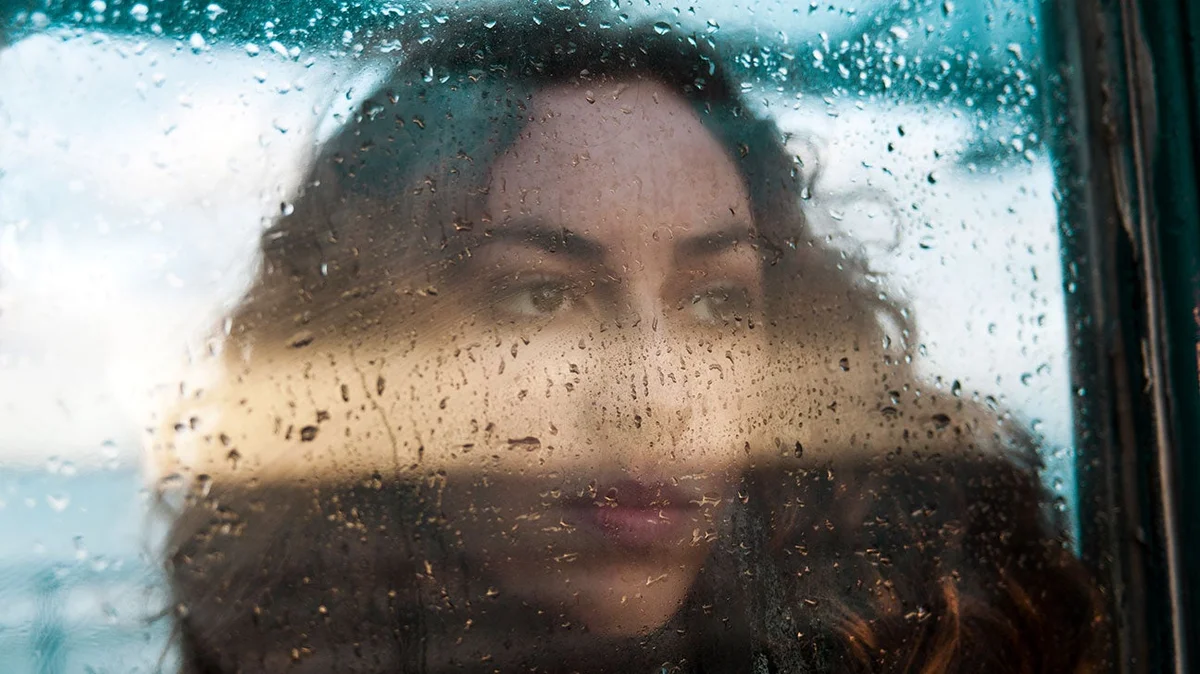 autumn depression signs woman window rain Czech mood
