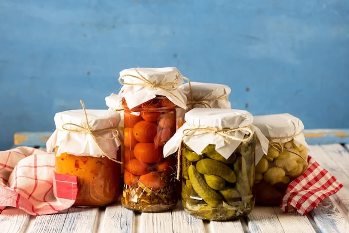 autumn vegetable pickling jars on wooden table