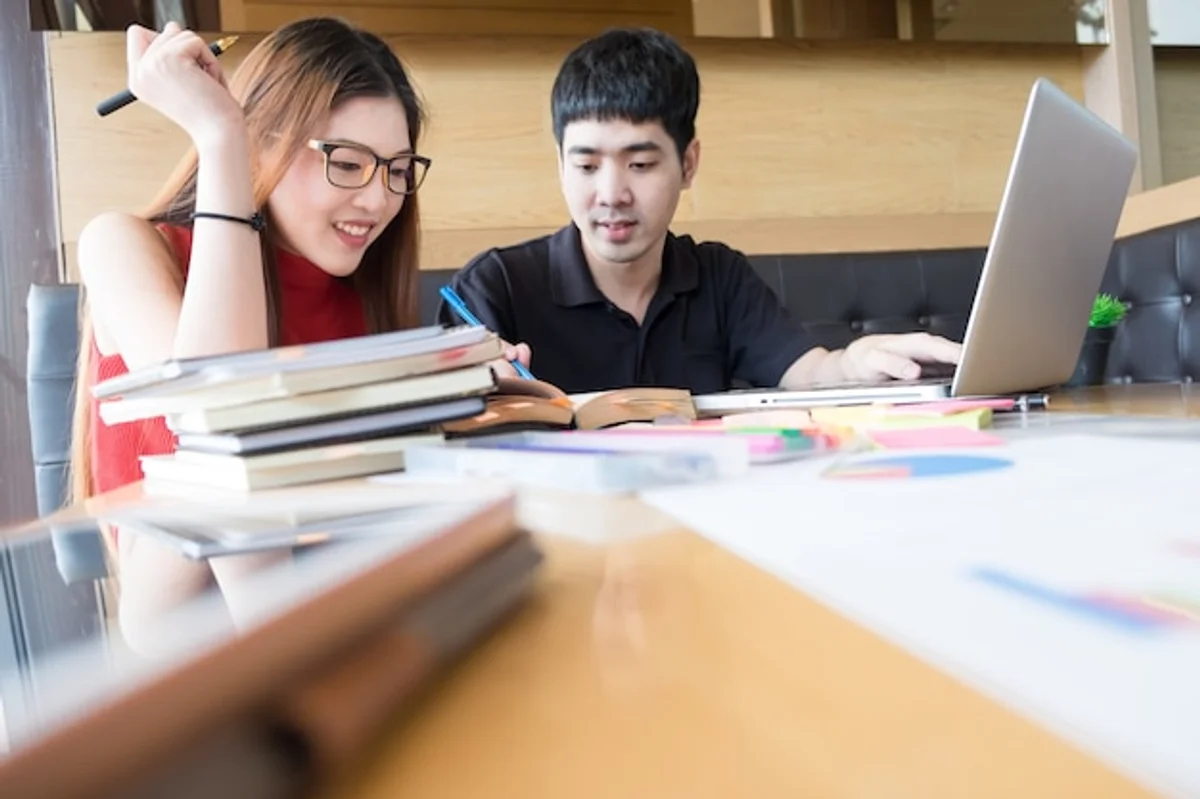 young adult learning language with notebook and coffee