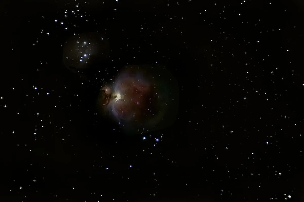 Close-up view Orion nebula through amateur telescope, night sky photography