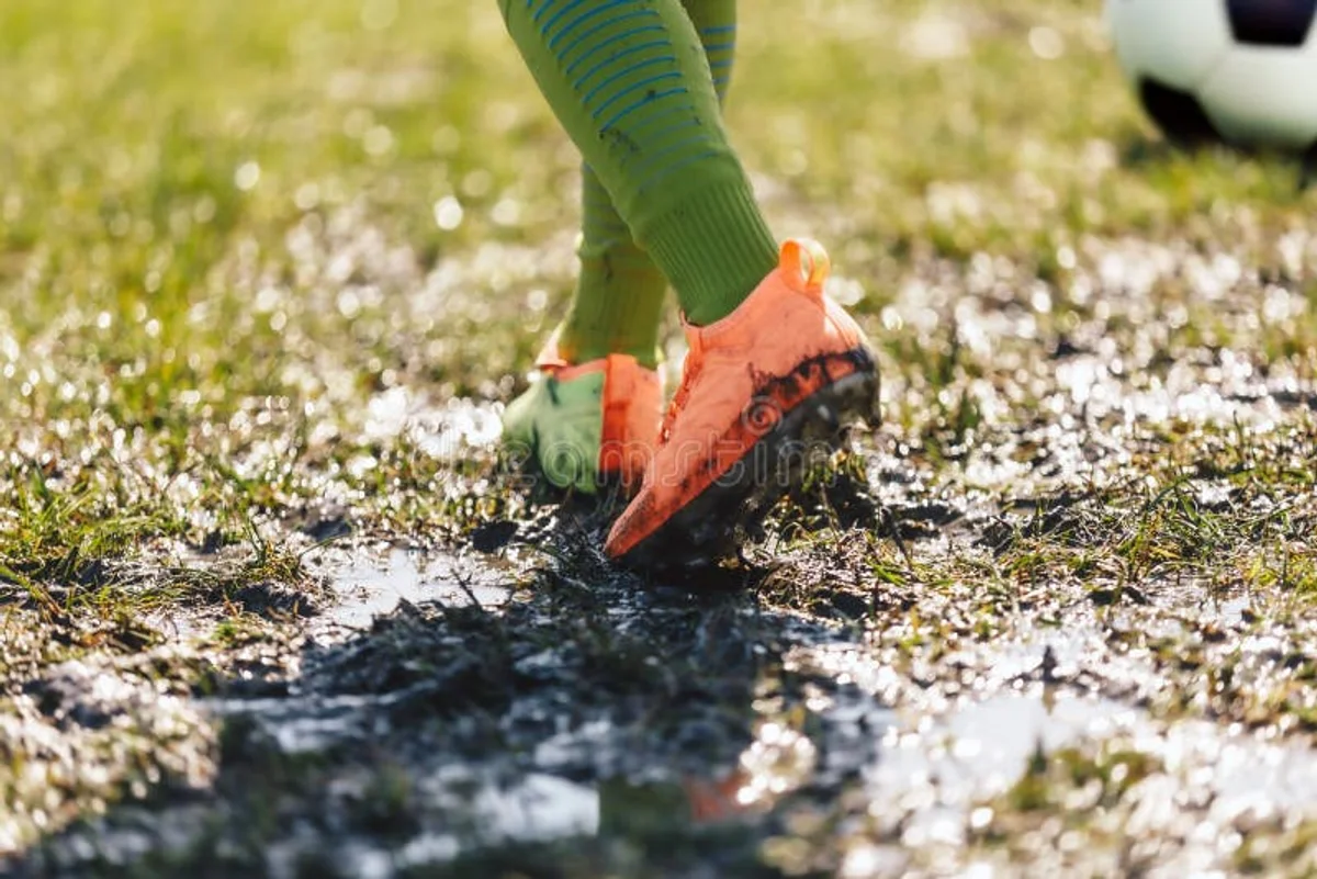football player muddy pitch autumn boots injury