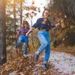 autumn travel mood happy people walking forest leaves