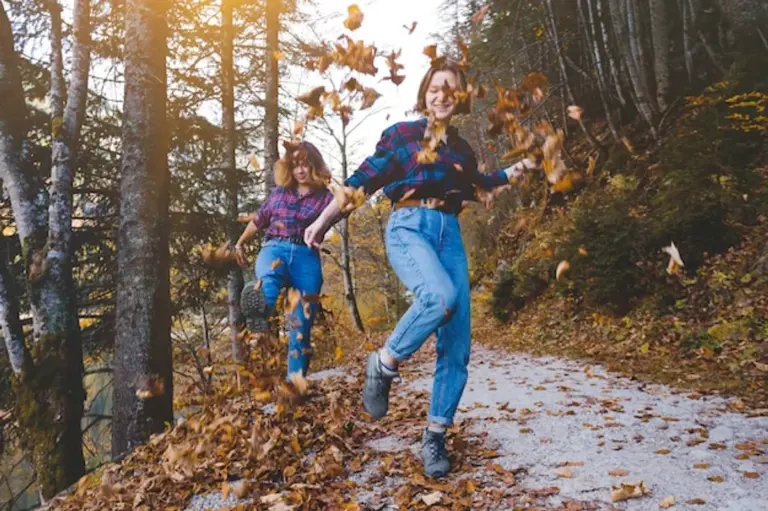 autumn travel mood happy people walking forest leaves