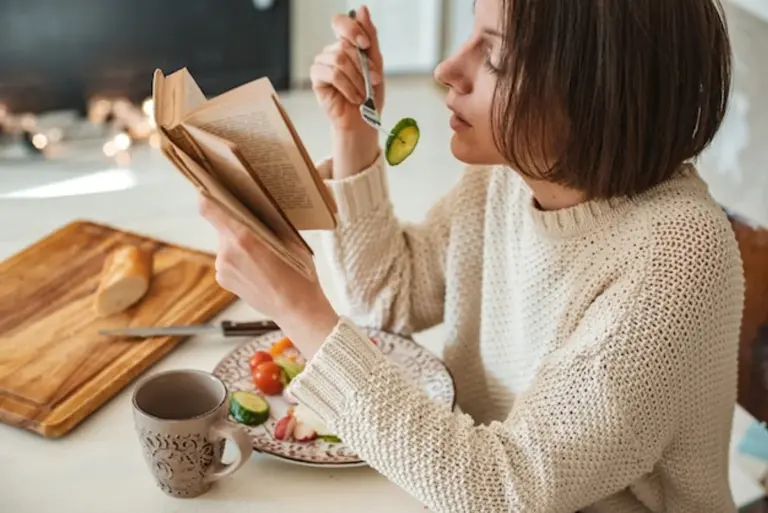 woman eating healthy food in cozy sweater winter mood
