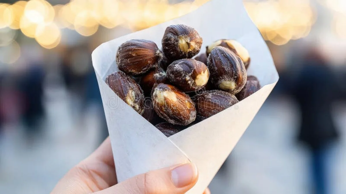 close up of hands holding roasted chestnuts on street market Prague