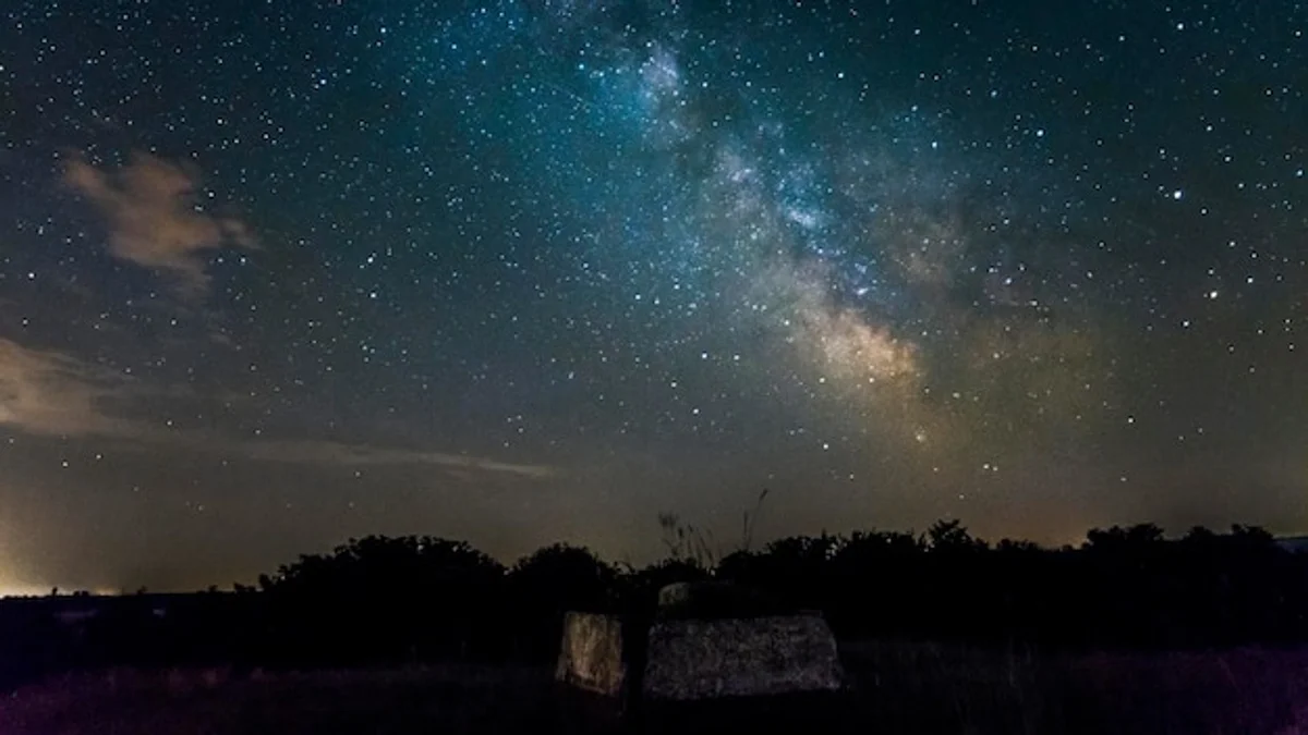 european countryside under milky way night sky