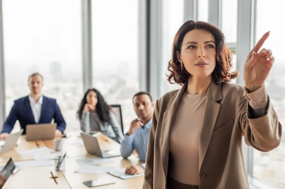 confident businesswoman using gestures during office meeting