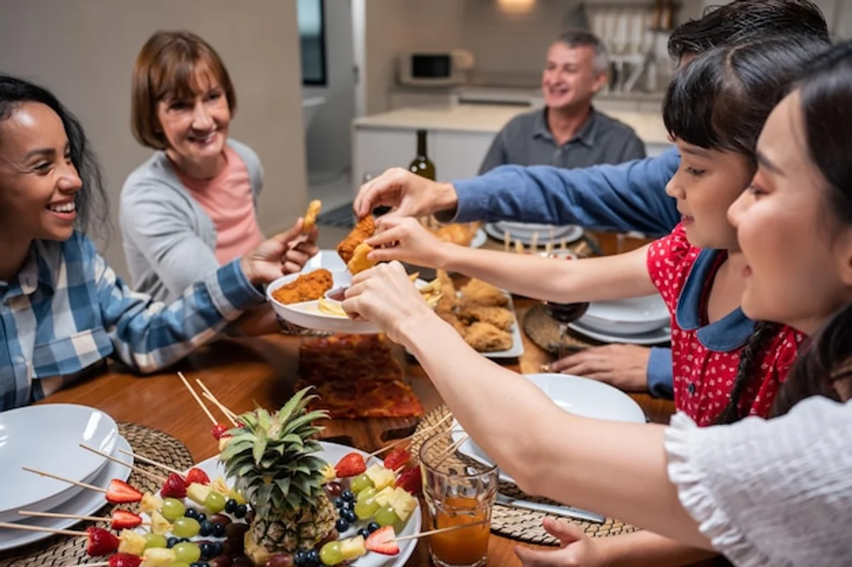 family having dinner talking together evening home