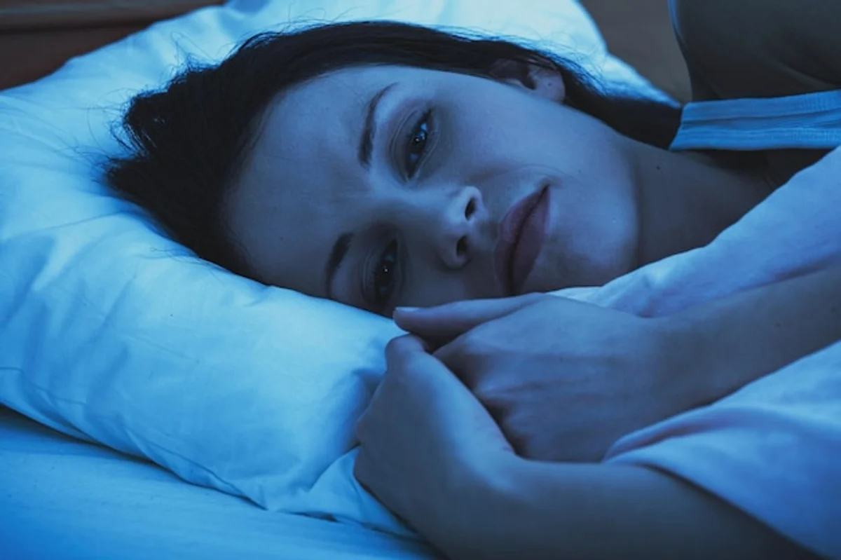 blue light sleeping smartphone woman bed