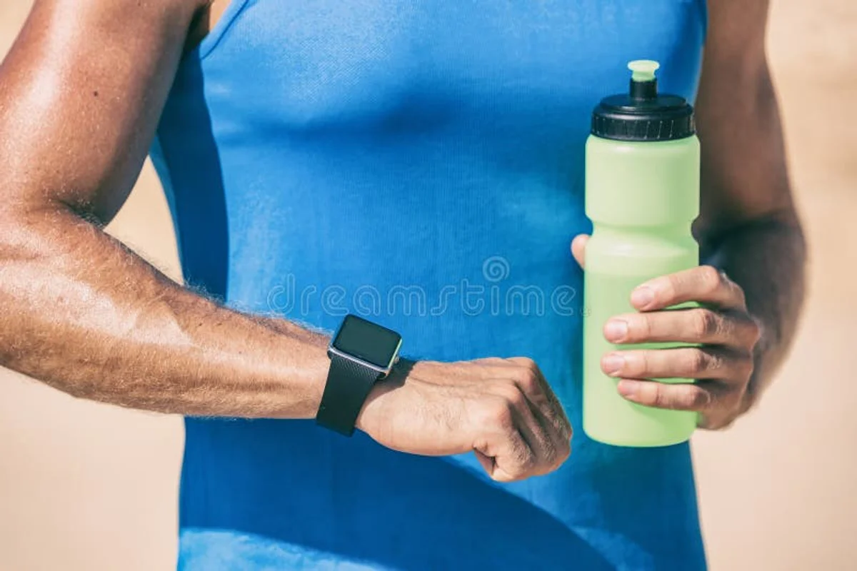 runner checking smartwatch hydration outdoor Czech nature