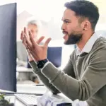 man frustrated by email mistake office