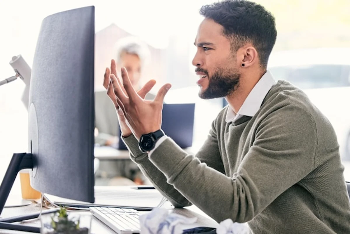 man frustrated by email mistake office