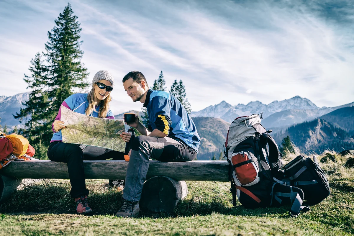 hiker using digital map in czech mountains winter safety