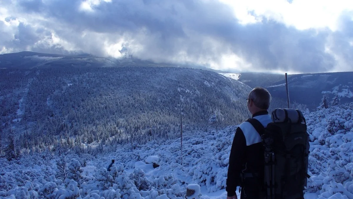 czech hikers using mobile outdoor map app winter krkonose