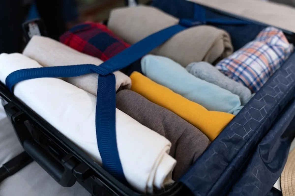 packing rolled clothes suitcase travel hack