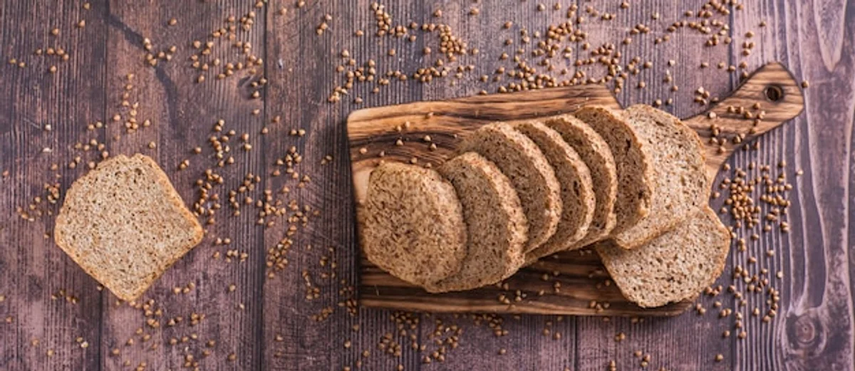 homemade slicing gluten free buckwheat bread on cutting board