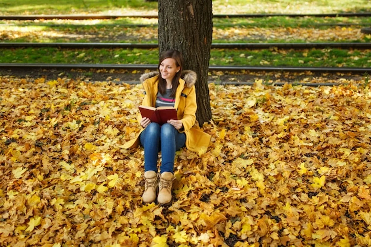 relaxed woman listening to music in tram autumn city